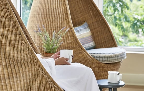 Person relaxing with cup of tea
