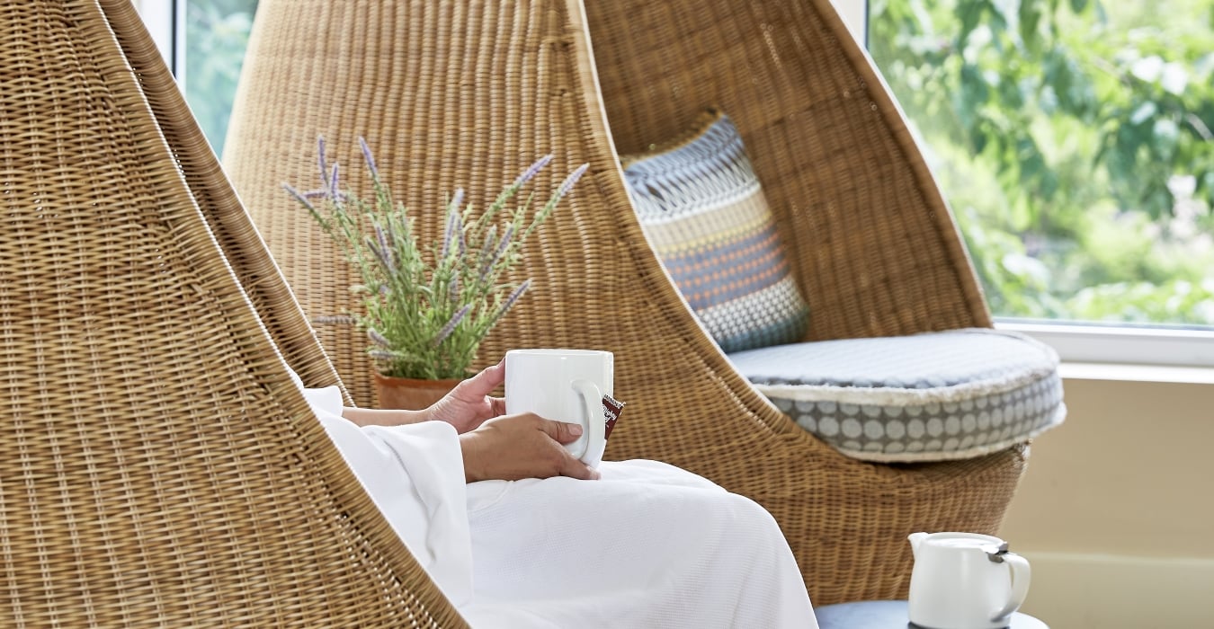 a woman relaxing at the spa with a cup of tea