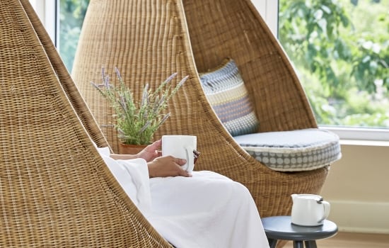 a woman relaxing at the spa with a cup of tea