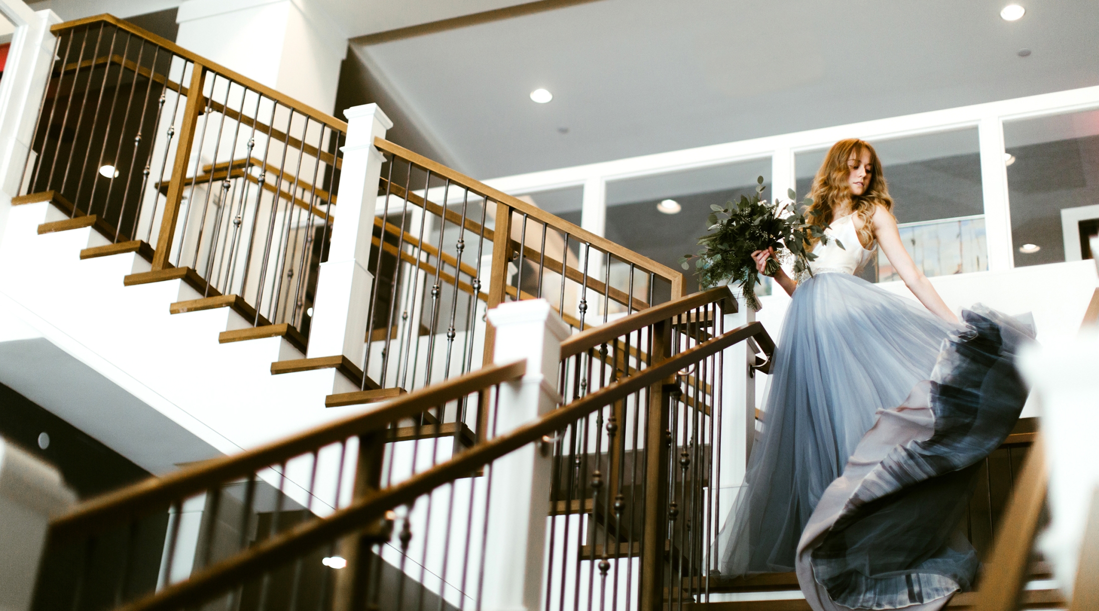 bride walking down steps at the hotel landing