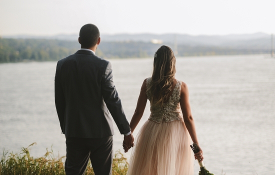 bride and groom overlooking lake