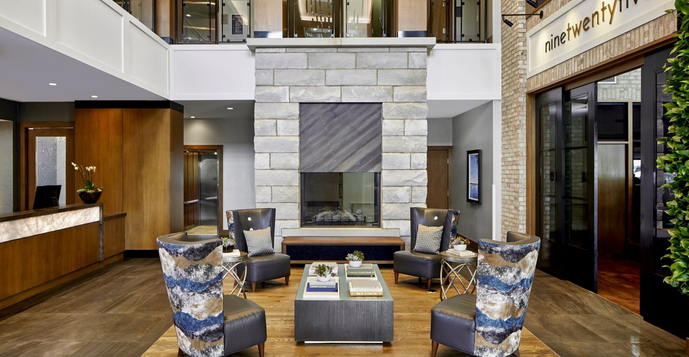 Hotel lobby with chairs in front of fireplace