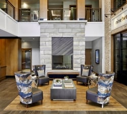 Hotel lobby with chairs in front of fireplace