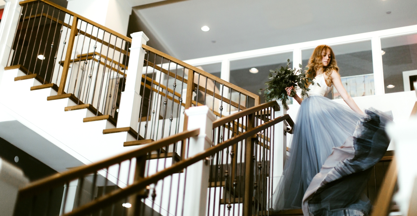 bride walking down steps at the hotel landing