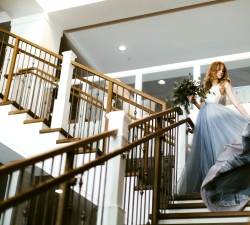 bride walking down steps at the hotel landing