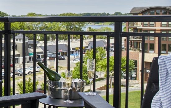 Champagne on ice with two glasses on a balcony