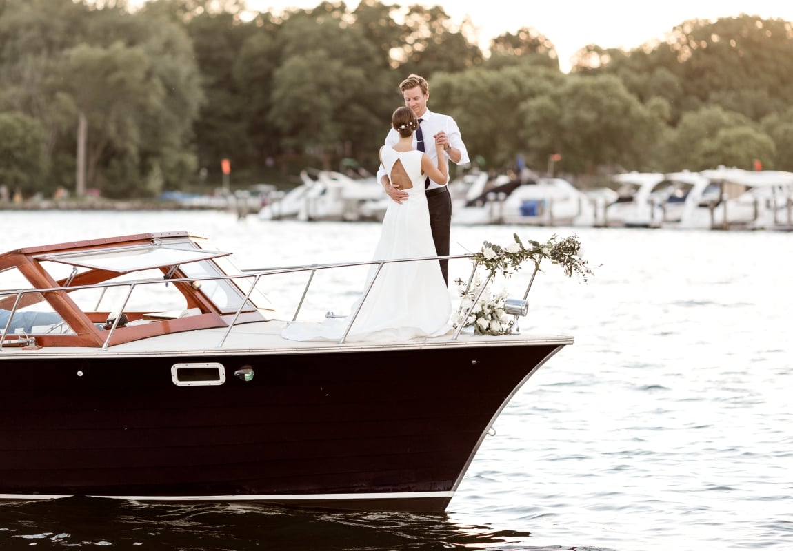 bride and groom dancing on boat