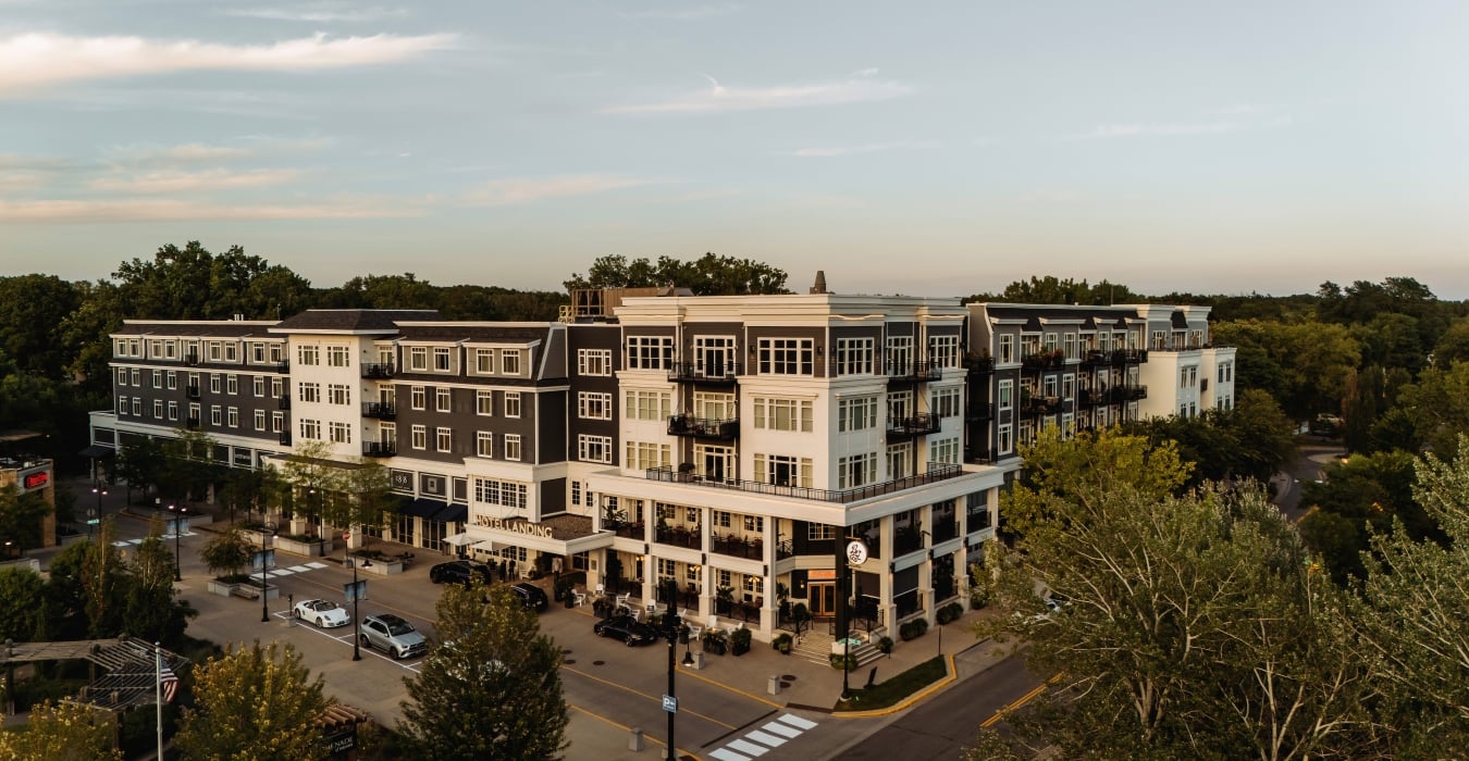 Aerial view of The Hotel Landing, a boutique lakeside hotel in downtown Wayzata, MN, at dusk