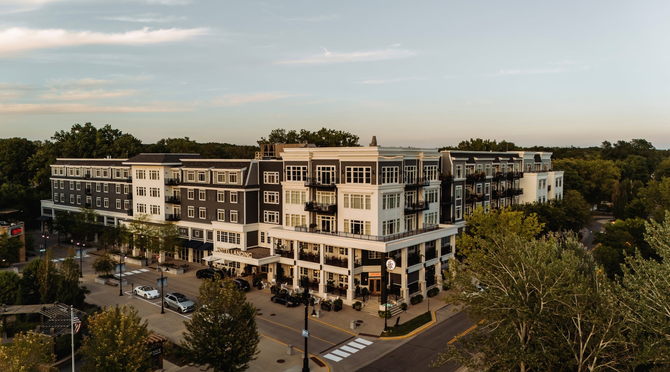 Aerial view of The Hotel Landing, a boutique lakeside hotel in downtown Wayzata, MN, at dusk