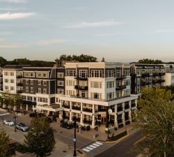 Aerial view of The Hotel Landing, a boutique lakeside hotel in downtown Wayzata, MN, at dusk